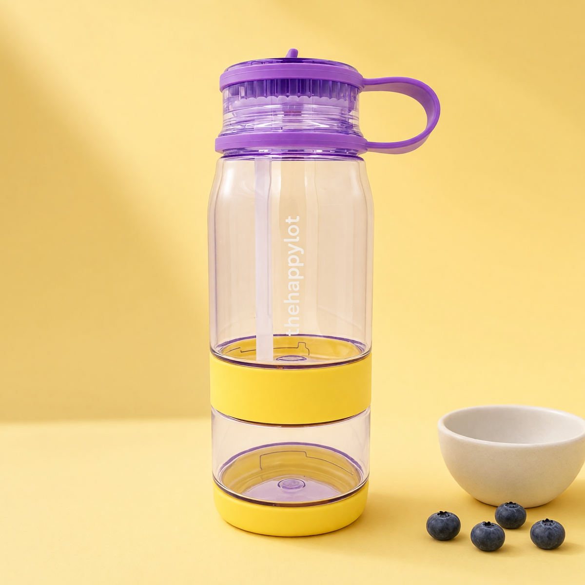 Children’s water bottle with a detachable snack cup in a yellow background